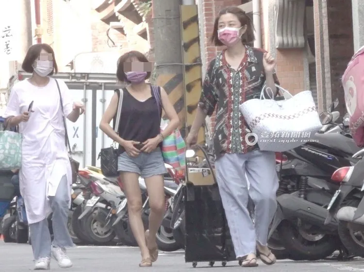 李維維（右）拉著推車，與友人們走向市場。特勤中心攝