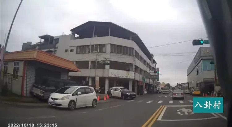 該部保安隊警車闖紅燈，對向騎士極為不滿，手指警車再比出中指。翻攝《八卦村》