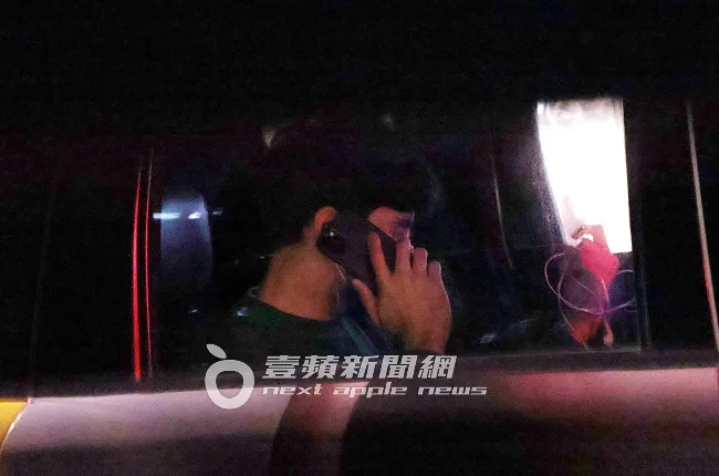 鳳小岳坐上計程車拿起手機通話，一邊伸進背包找耳機線。特勤中心攝