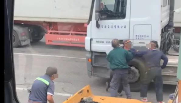 吳姓保全員抓住大車司機，卻也被對方掐住脖子。讀者提供