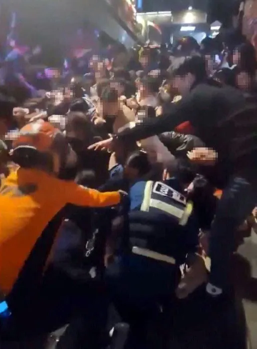 消防人員從現場堆疊的人體中使勁拉拔,費很大力氣才救出一個人。路透社