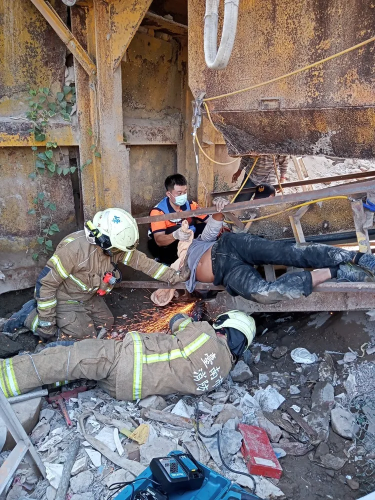 警消出動鋸開輸送帶鐵架。讀者提供