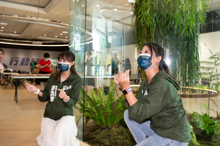 蔡其昌競總設有透明植生區，立委林楚茵與后豐區市議員候選人廖芝晏忍不住再植生區前合影。蔡其昌競總提供