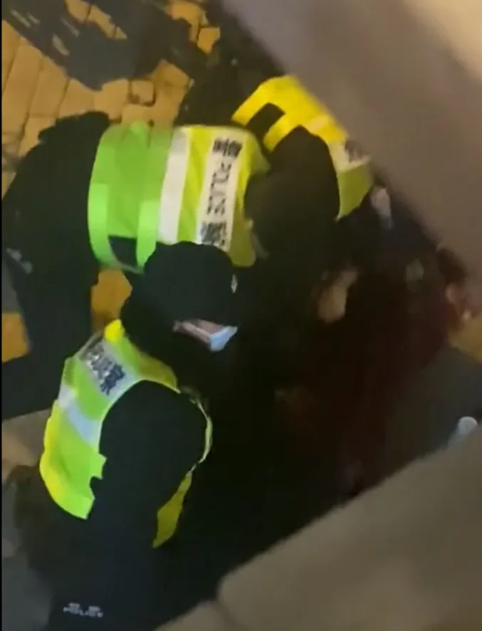 勞倫斯被三名員警壓在地。翻攝推特