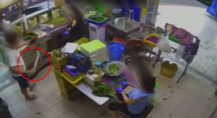 李姓男子從刀鞘抽出開山刀（紅圈處）。讀者提供