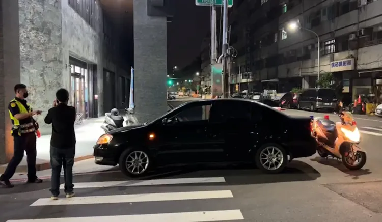 黑車的車主陳姓女子在車輛遭撞後，打電話連繫拖車來處理。讀者提供