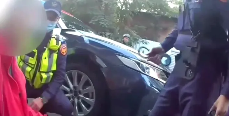 警員拿出手銬將許男上銬逮捕。讀者提供