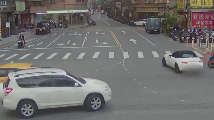 白色轎車行經路口左轉，重機(紅圈處)見狀煞車不及。板橋警分局提供