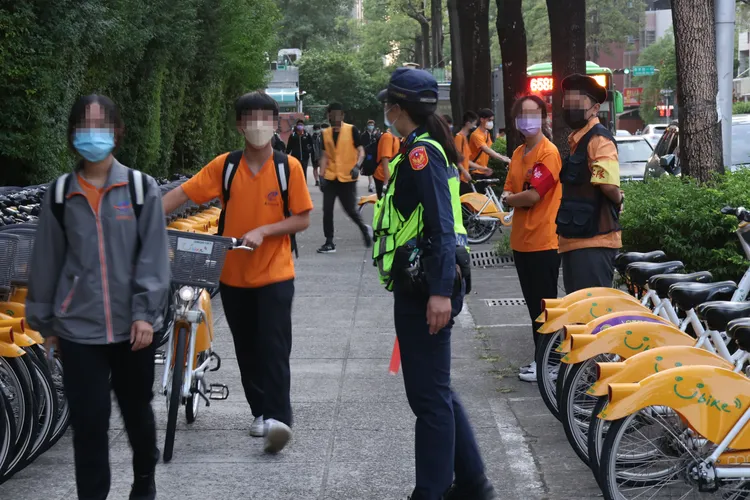 警察取締學生在人行道騎Ubike。張喆喜攝