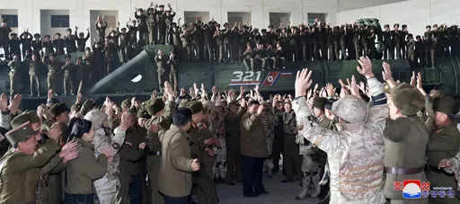 骨牌式摔車現場！　多名北韓軍人與金正恩合照時從飛彈發射車上摔落