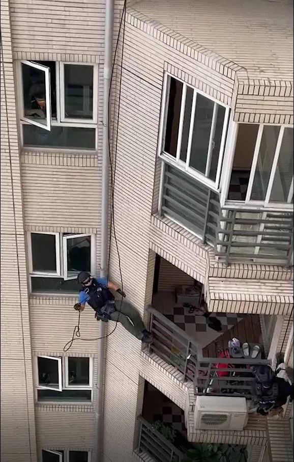 刑事局南打派人垂降到大樓13樓，攻堅進入屋內逮捕陳嫌。讀者提供