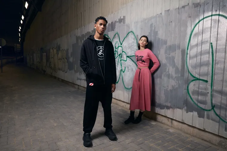 Authentic系列以SPORT b.不對稱圓形標誌、「Keep Going」塗鴉字樣及紅白條紋警示線等元素，創作出簡約中性風格的運動時尚裝束。品牌提供