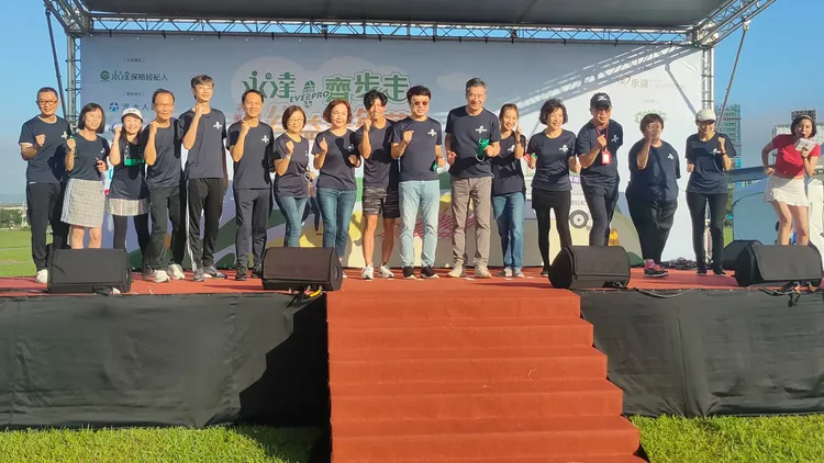 永達保經主管上台振臂合照。黃子騰攝