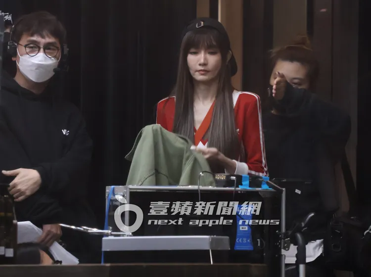 逆齡女神謝金燕（中）將外套脫下，準備繼續拍攝工作。特勤中心攝