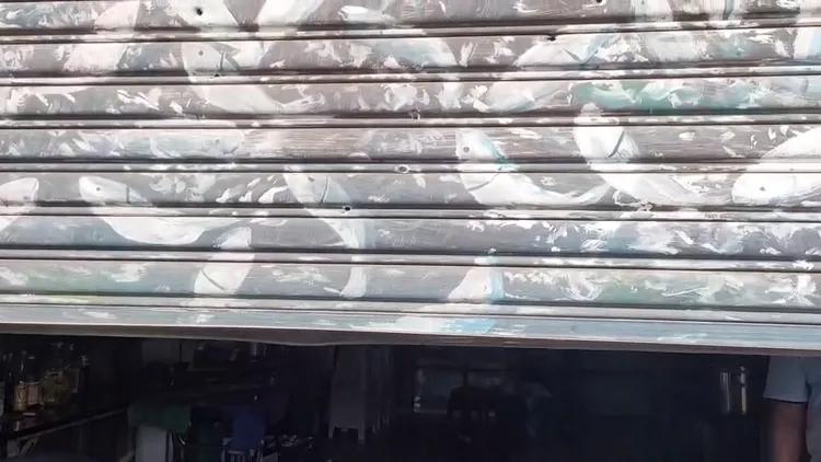 遭槍擊的台南市議員謝財旺服務處，鐵捲門滿是彈孔。資料照片