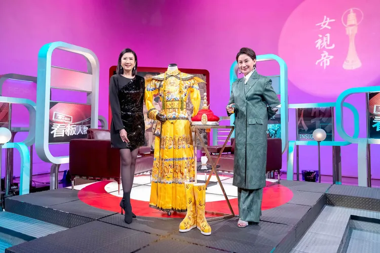 陳亞蘭（右）在錄影現場向方念華展示劇中專屬龍袍。TVBS提供