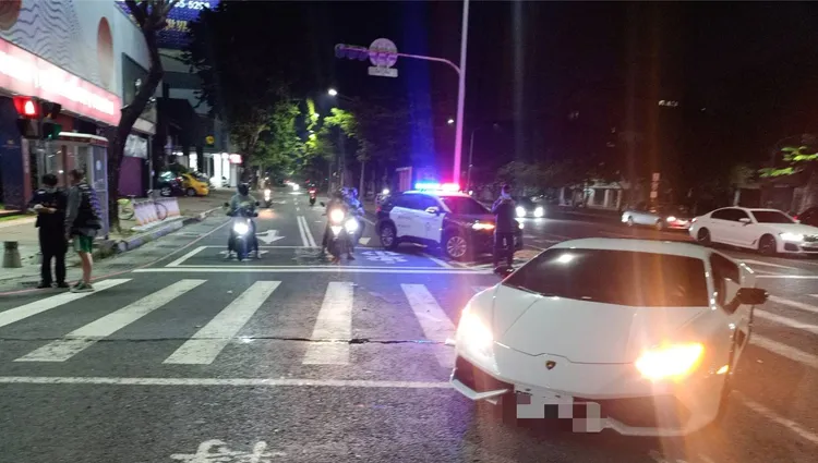 藍寶堅尼停在快、慢車道間等右轉燈號，遭後方倒地機車滑行撞上。讀者提供