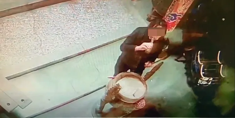 呂男將雞頭埋入香爐。民眾提供