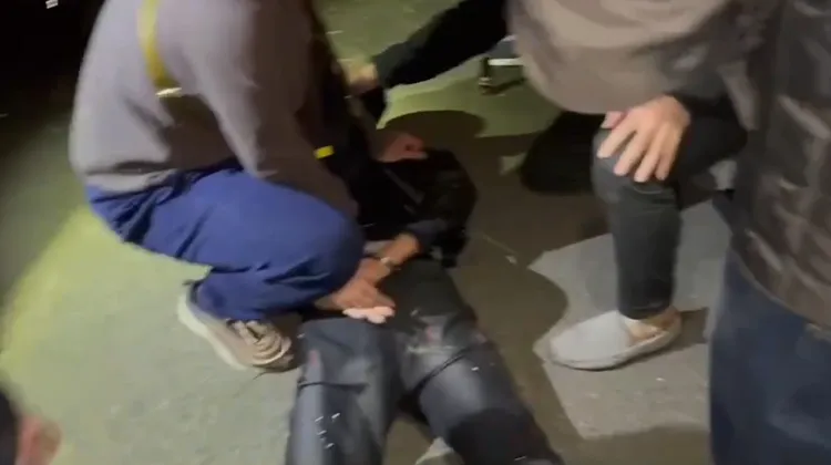 搶匪遭警方壓制在地上。讀者提供