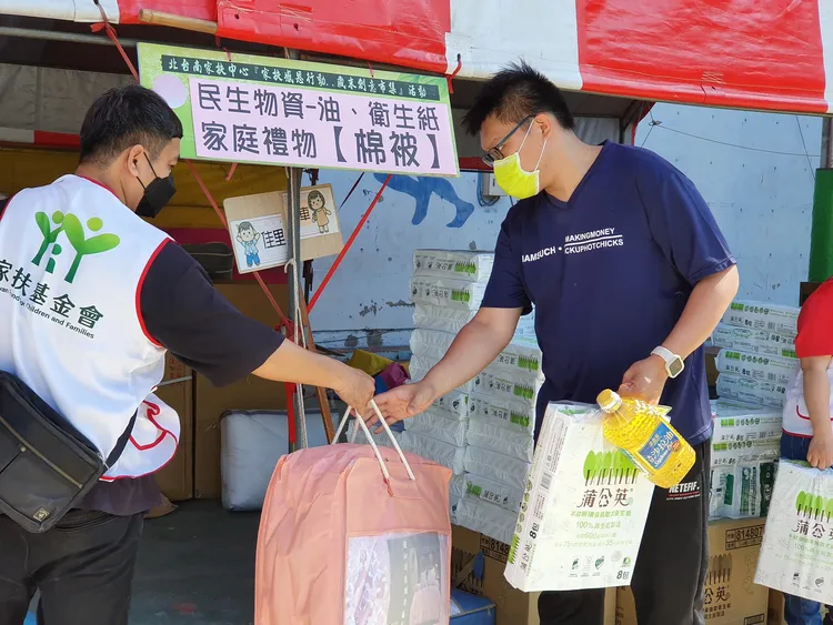 會場發放物資給受扶助家庭。王志弘攝