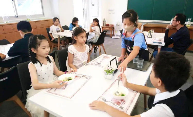 學生說，穿正式服裝用餐，會不自覺地放慢吃飯速度，拿餐具的動作也變優雅。校方提供