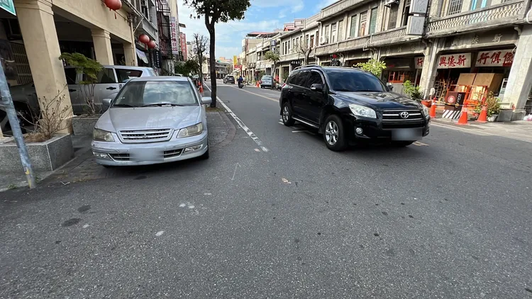 照片左側銀色轎車雨刷上夾著2張違規停車逕行舉發單。魏嘉良攝