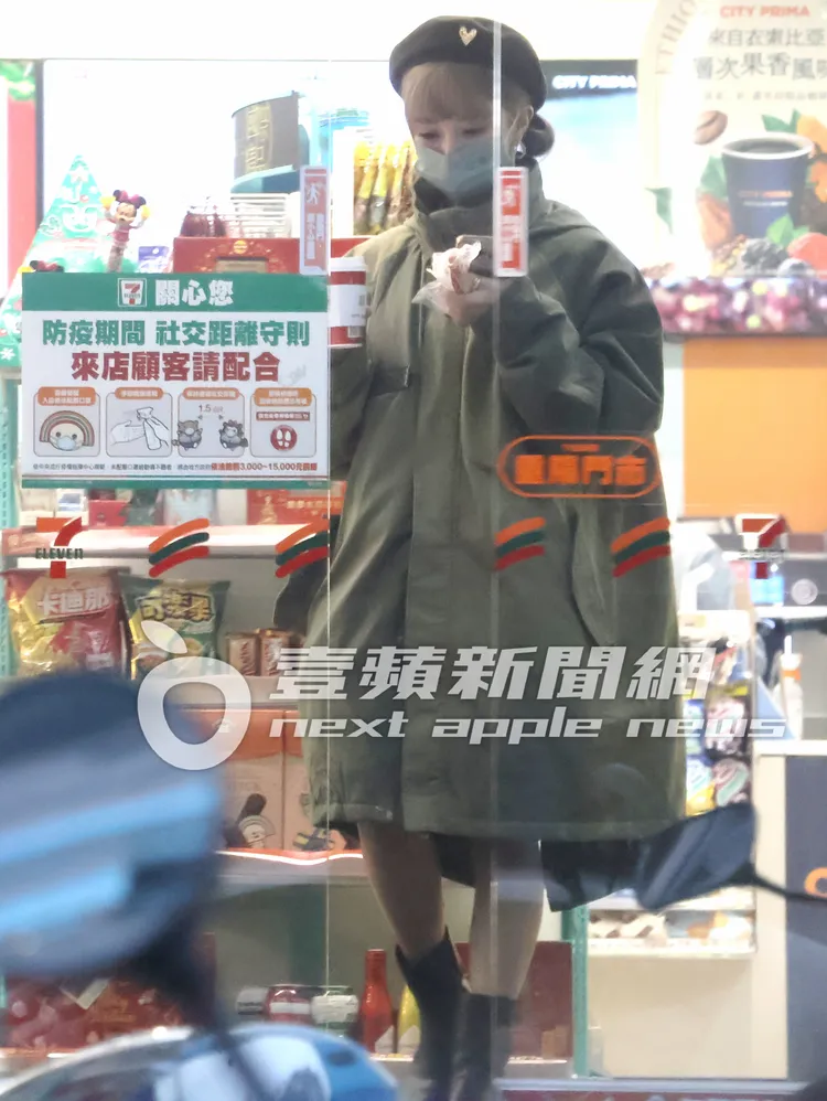 啦啦隊女神巫苡萱手握19公分大熱狗和咖啡，步出便利商店。特勤中心攝