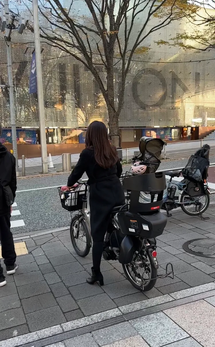 麻衣騎車電動腳踏車，看似準備接兒子下課。娛樂中心攝