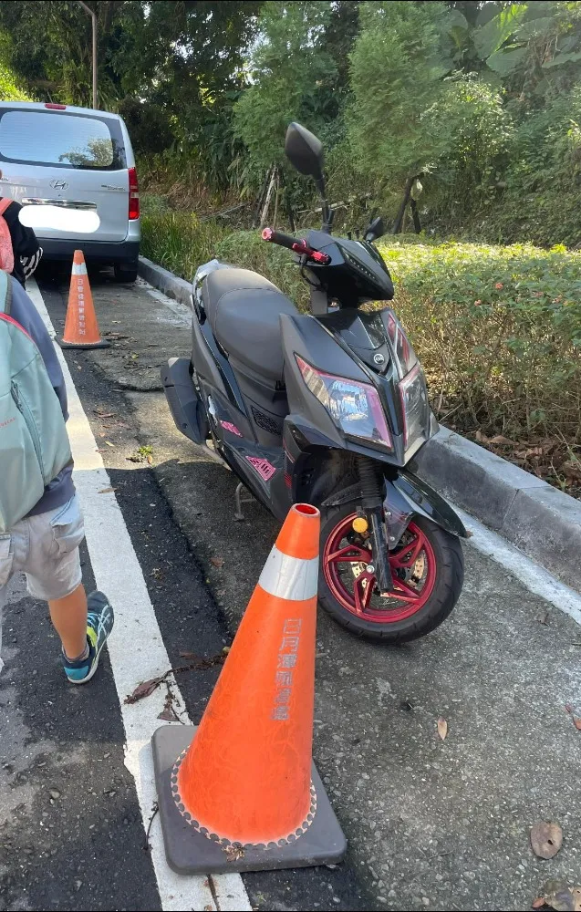 該車位被三角錐及機車佔用，網友差點因此被收費200元。翻攝爆料公社