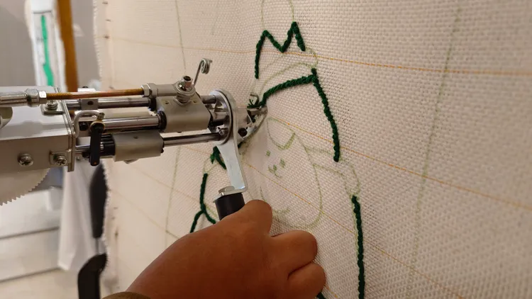 運用簇絨槍槍頭快速穿過織物，呈現出刺繡的效果。翁玉信攝