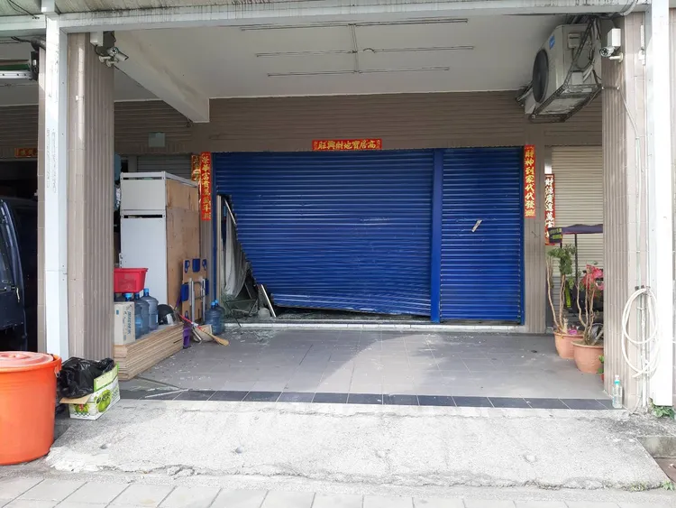 遭衝撞的鐵捲門。讀者提供