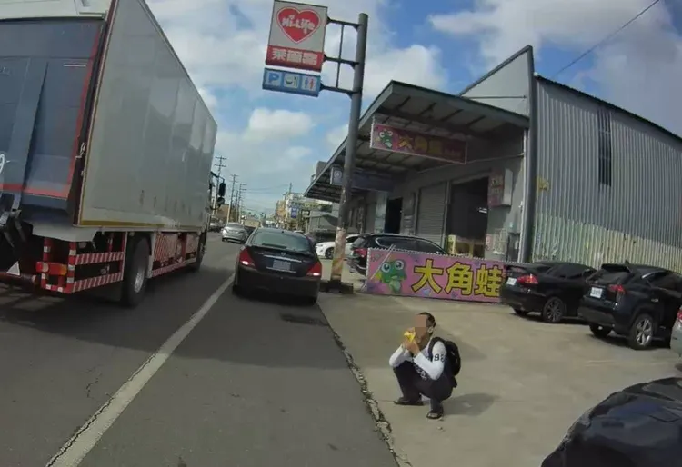 警方趕到後,潘男蹲坐在路邊吸膠。大園警分局提供