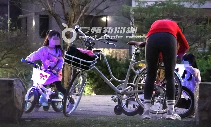 鄒琳（右）幫女兒收拾隨身物品，單車置物籃發出閃閃藍光，宛如台灣燈會花燈般絢彩繽紛，十分應景。特勤中心攝