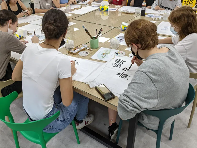 北市學生帶領外籍生體驗寫書法、珍奶DIY等台灣文化。教育局提供