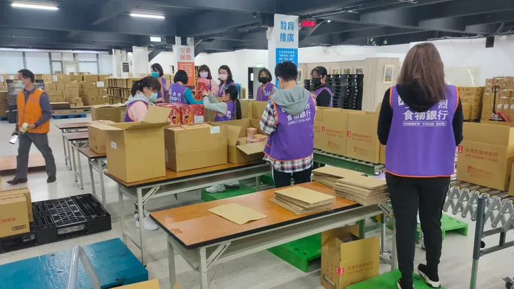 志工以生產線方式包裝食物箱。黃子騰攝