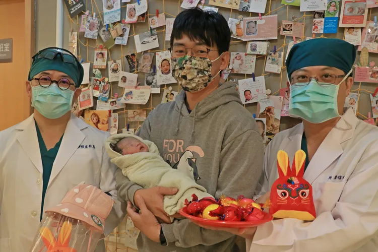 茂盛醫院婦產科醫師廖敬慈與廖信明醫師代表院方致贈防疫帽與金兔娃娃給元旦寶寶家長。茂盛醫院提供