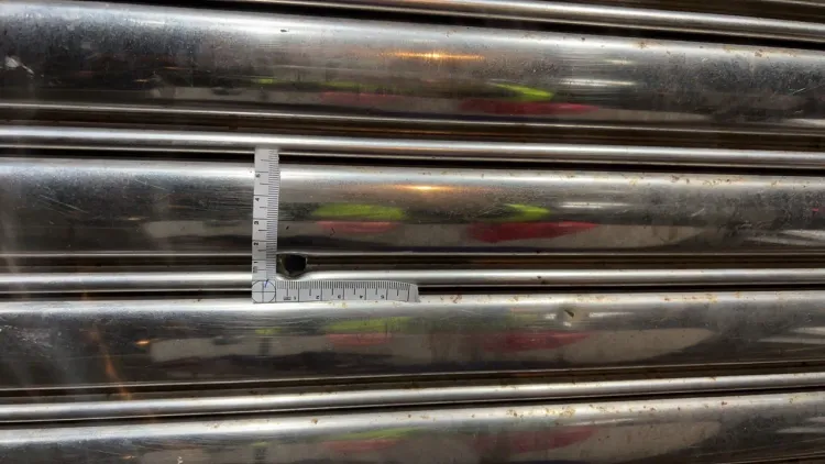 子彈擊穿一旁民宅鐵捲門，打中在鐵捲門後方的蕭姓男子。讀者提供