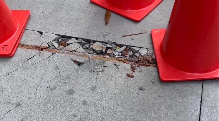 500公斤重的實木桌墜落意外發生五天後，當地人行道仍留有一個大洞。讀者提供