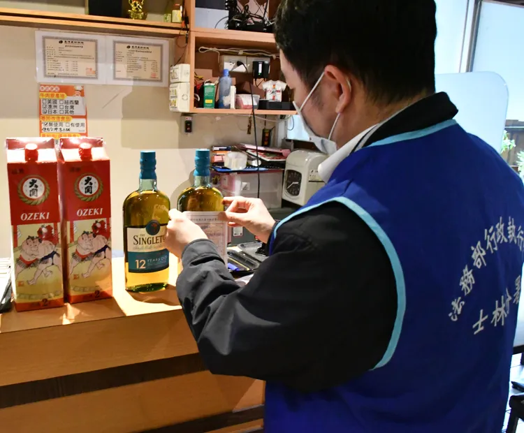 執行人員查扣潘男日式料理店內酒類。行政執行署士林分署提供