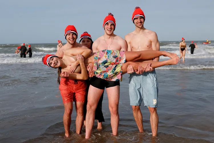 「我要打3個！」大媽由3枚小鮮肉抱起，不忘護胸防走光。路透社