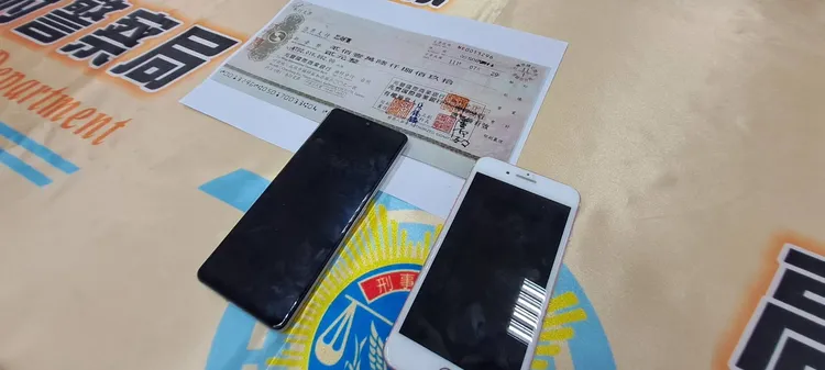 刑大查獲做案手機兩隻，現金支票一張等證物。讀者提供