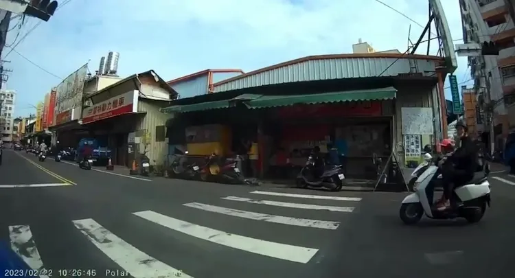 腳踏板還站了1名幼童的吳男，闖紅燈被另名騎士按喇叭示意。民眾提供