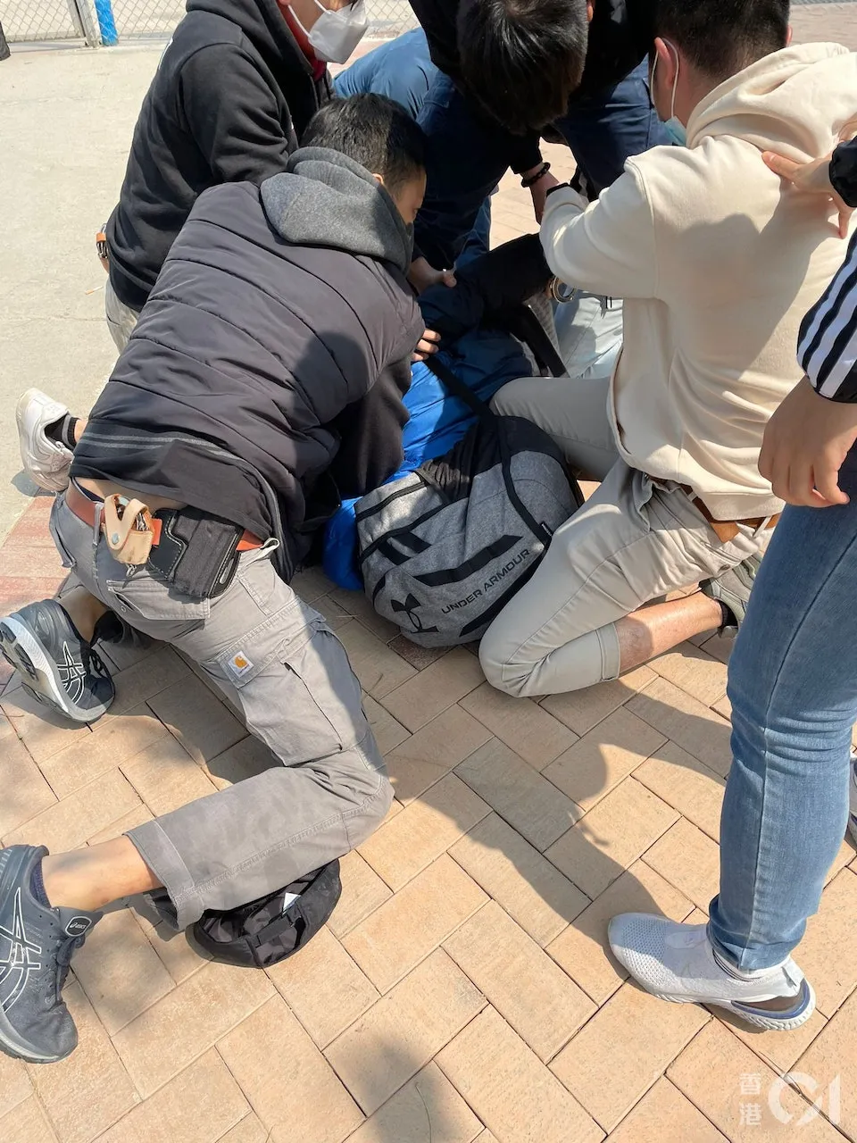 兇嫌鄺男潛逃前落網,遭多名警員壓制。翻攝自《香港01》