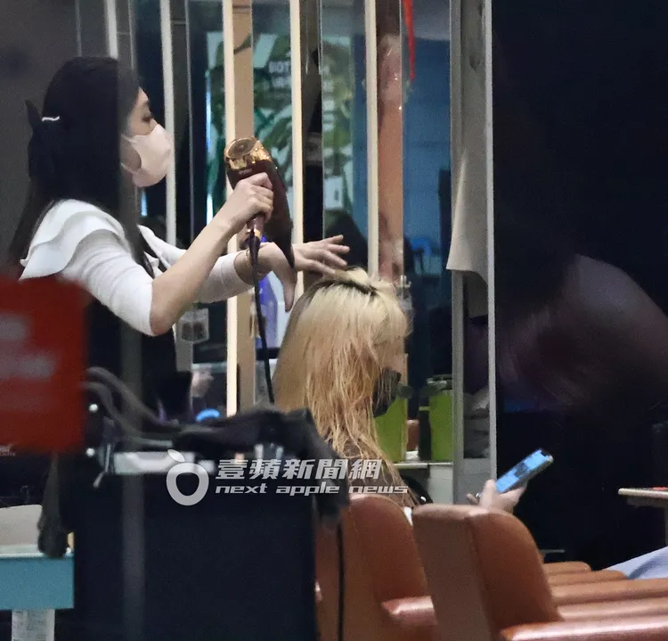 王心恬（右）吹頭髮時不時滑手機。特勤中心攝