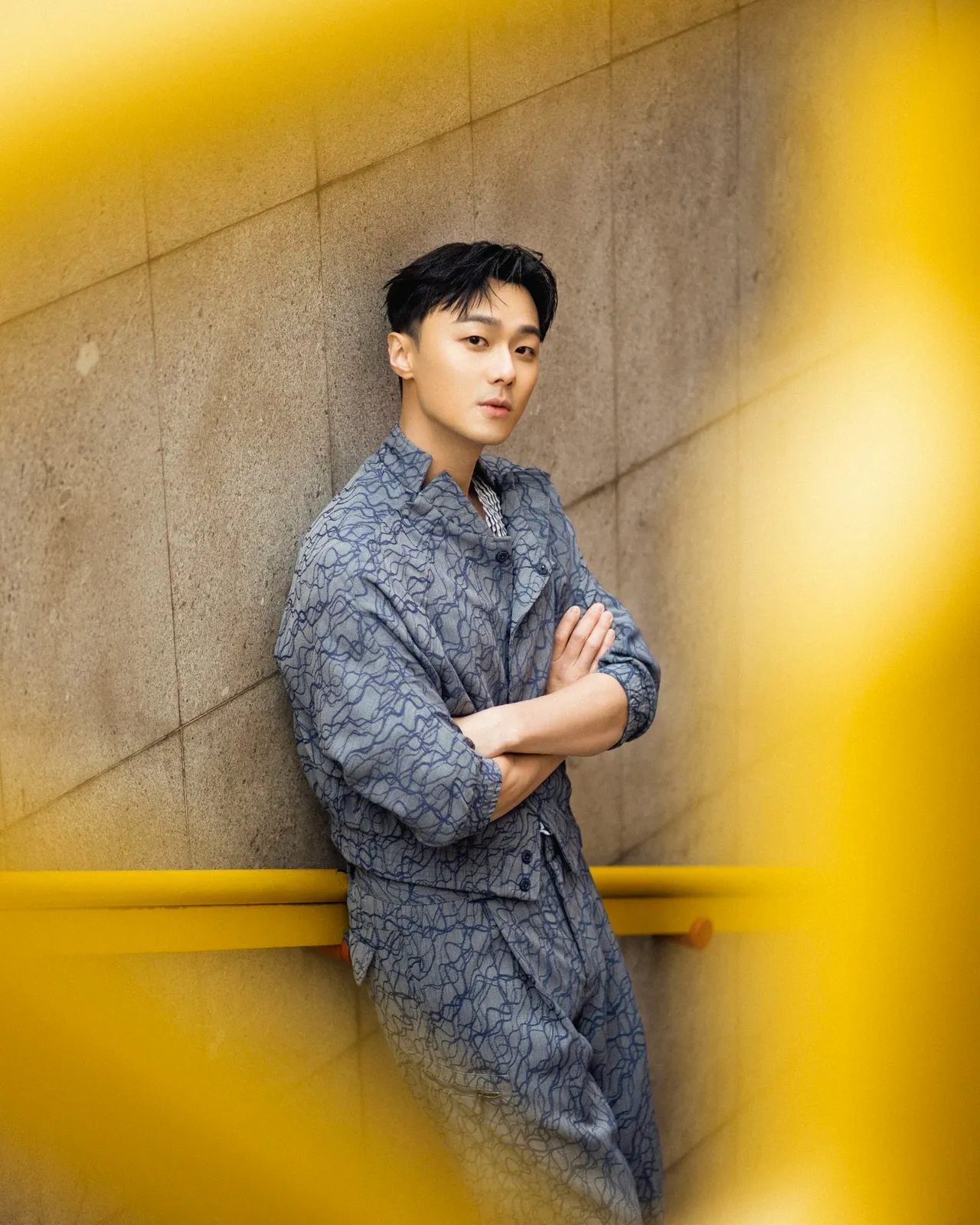 施柏宇穿著EMPORIO ARMANI 2023春夏系列藍色波浪印花外套及同款褲裝漫步米蘭街頭。品牌提供