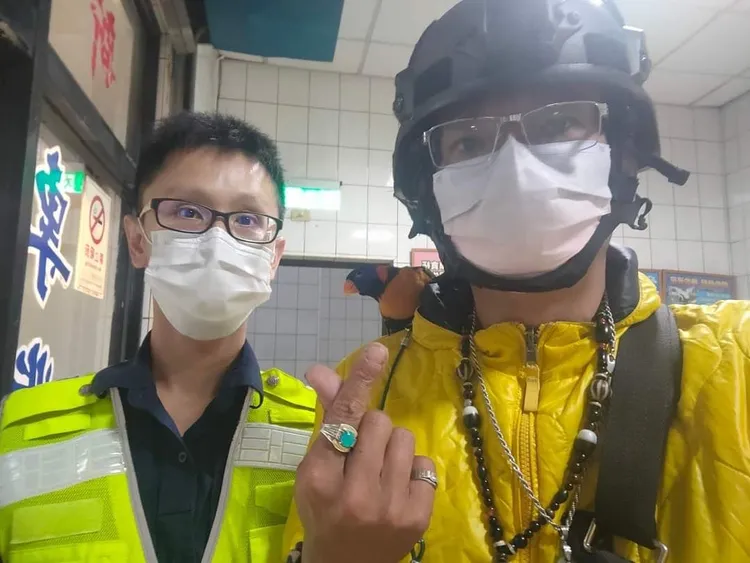 江姓失主到派出所領回「古錐」，牠乖乖站在主人肩膀上。讀者提供