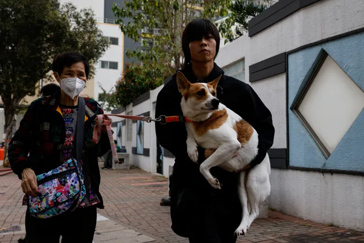 火場附近居民抱著愛犬逃難。路透社