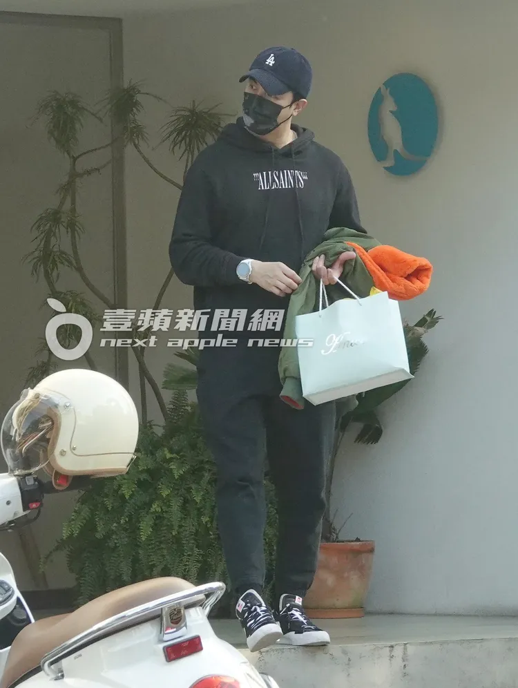 當天一身黑的謝佳見手提外套、紙袋走出咖啡廳。特勤中心攝