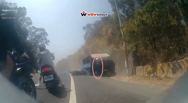  藍色貨卡衝向對向車道時，白帽女騎士跳開機車往後跑，幸運躲過死劫。翻攝「WoWtchout-地圖型行車影像分享平台
