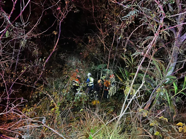 警消及搜救人員下到邊坡，合力將騎士拉上路面。讀者提供